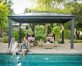 In a garden gazebo with garden furniture, friends are having a conversation beside a pool