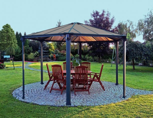 Hexagon gazebo on garden patio with dining furniture
