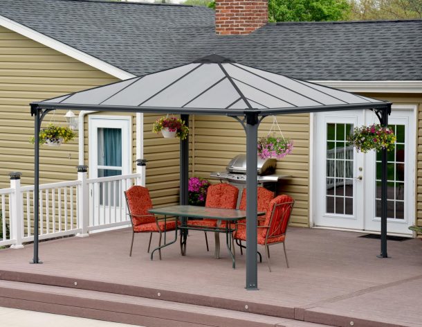 Palermo 12'x12' grey aluminum gazebo with polycarbonate roof panels on a deck patio with garden dining furniture