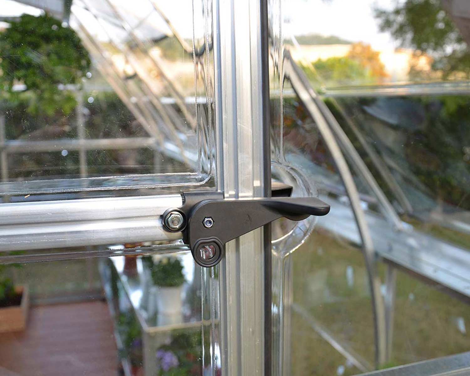 close up door lock of Americana Greenhouse with clear panels