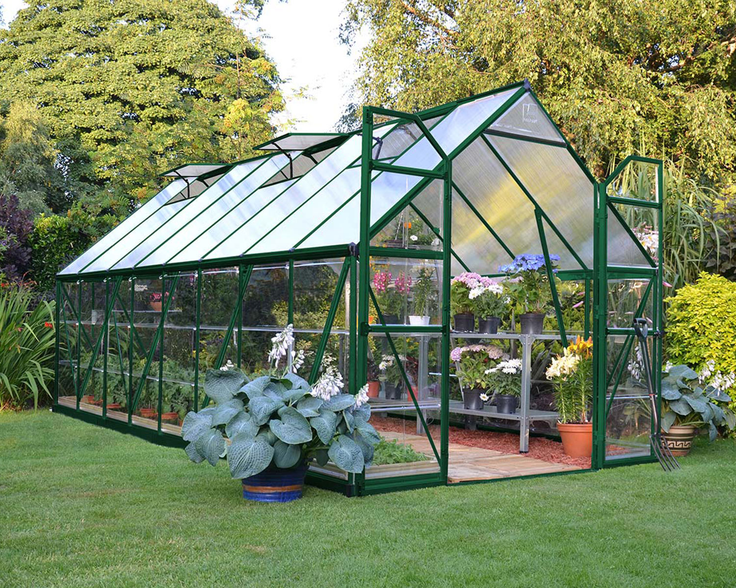 Greenhouse Balance 8' x 16' - Green Structure & Hybrid Panels open door on a lawn full of plants