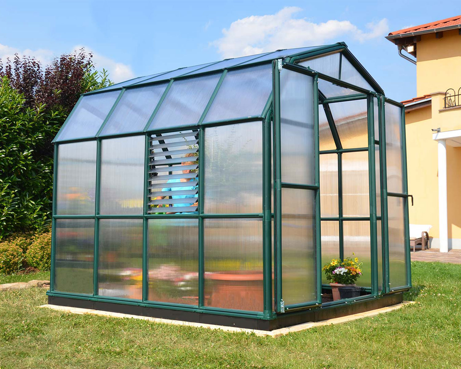Greenhouse Prestige 8 ft. x 8 ft. Green Structure & Twin Wall Panels on a lawn