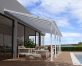White Aluminium Patio Cover With Clear twin-wall polycarbonate roof panels on Beside Pool Patio protect garden furniture
